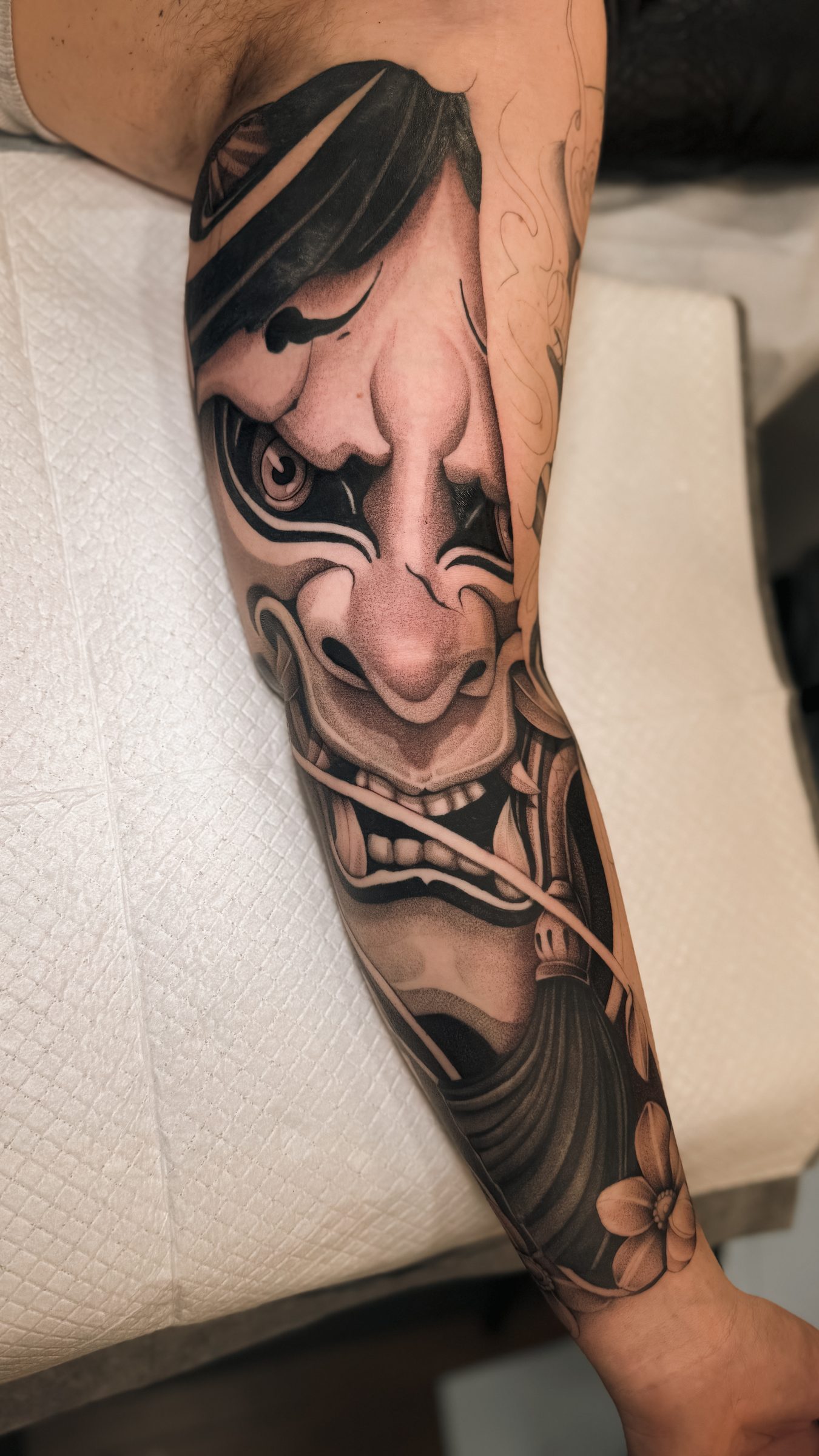 Hannya mask tattoo on forearm, black and grey, by Kel Otero