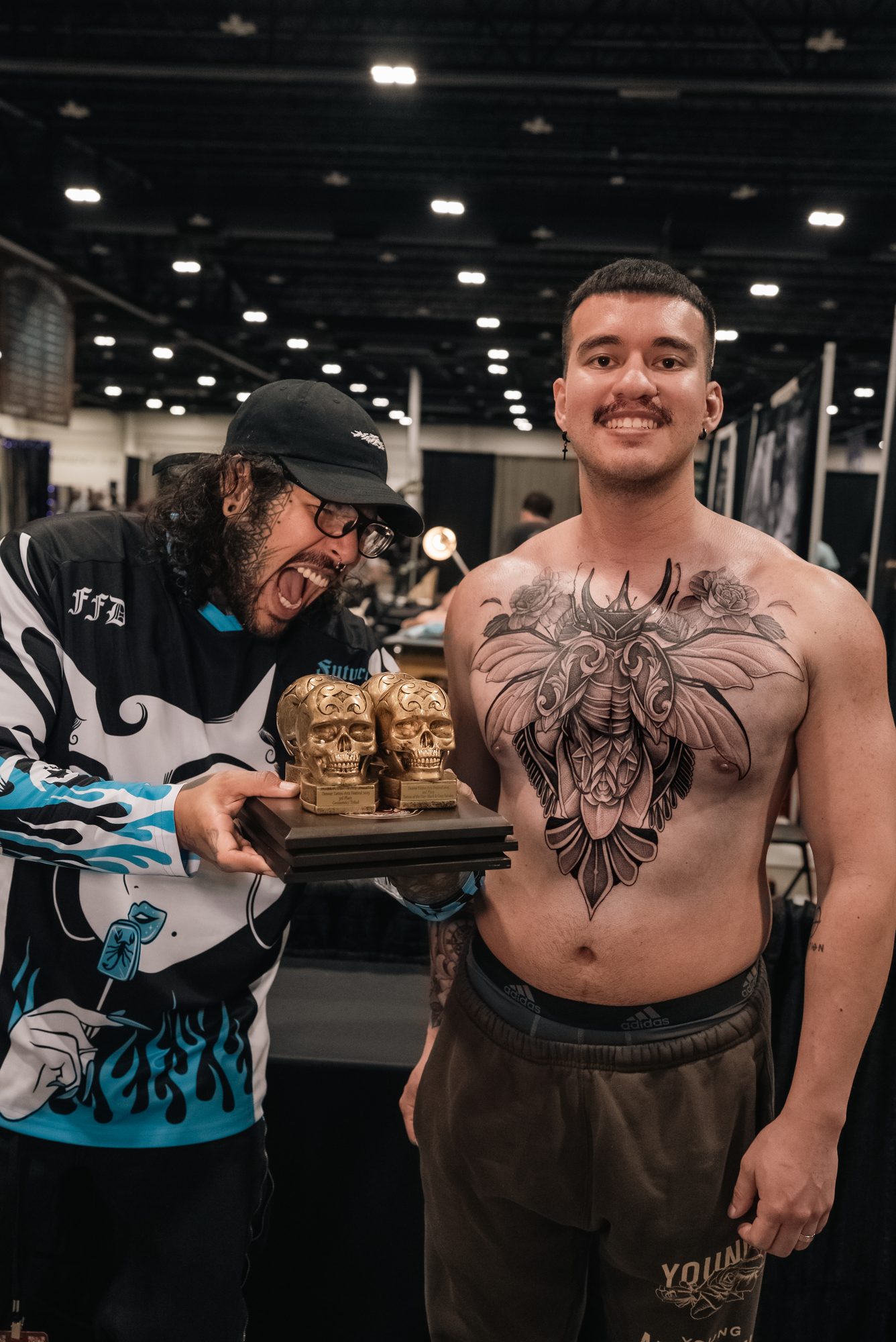 Kel Otero and his client holding their awards at the Denver Tattoo Arts Festival 2025